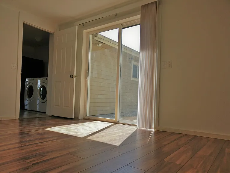 Large bedroom with sliding door access to private patio.