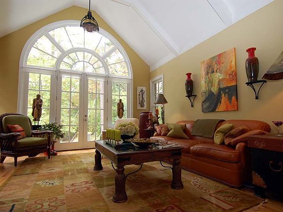 Step through archway to sunroom w/vaulted ceiling, beams, & beautiful windows!