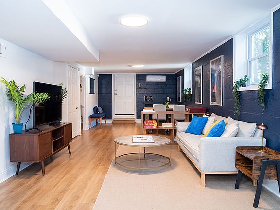 Spacious open-concept dining and living room area filled with tons of natural light.