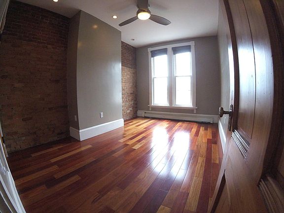 City facing bedroom: Exposed brick ; Original gumwood door
