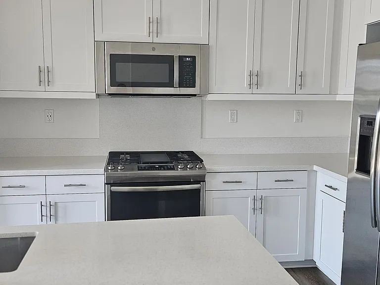 Gas stove with flat pan in center and microwave. Lots of Storage.