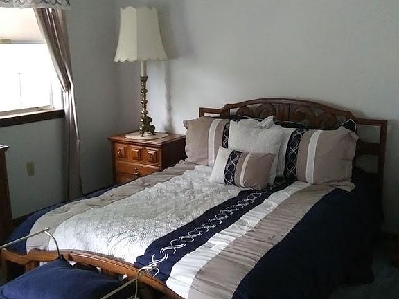 Freshly decorated bedroom with full bed, 2 nightstands, 2 Hollywood Regency lamps, a dressing bench, 2 large dressers, and an impressive walk-in closet give you plenty of space for your personal things and a relaxing night's sleep.
