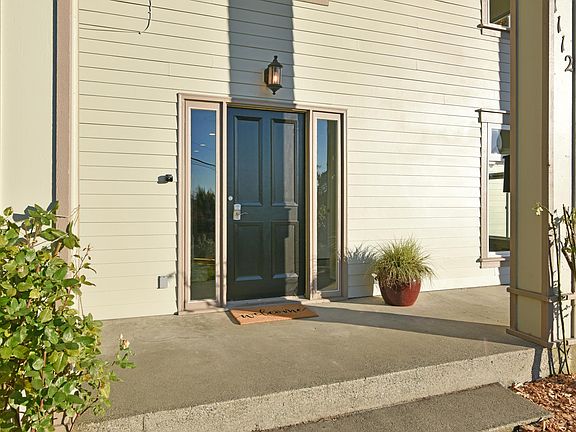 Front Entrance invites evening sitting and potted plants.