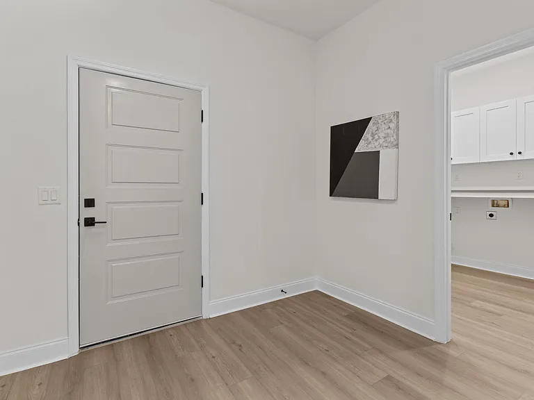 Door to garage, indoor laundry on right