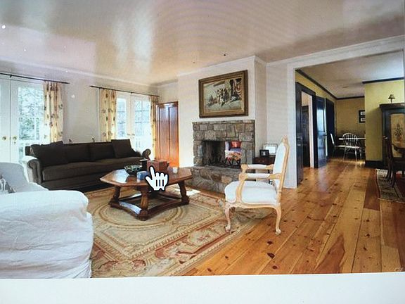 Living room with fireplace and two French doors opening onto