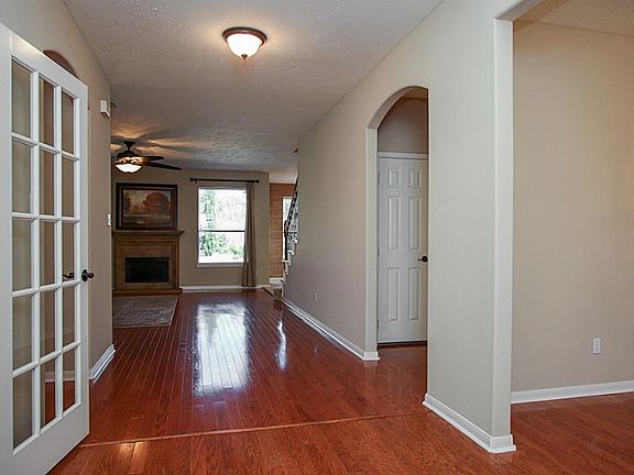 Elegant two story entry flanked by office and formal dining.  Wood floors in entry, office, dining and den.