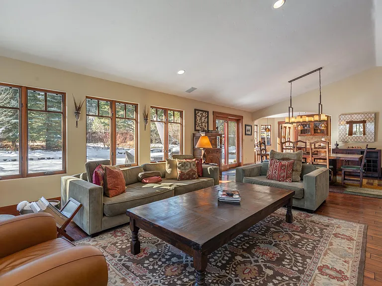 Open concept Living Room and Dining Room for eating or relaxing next to a stunning stone fireplace