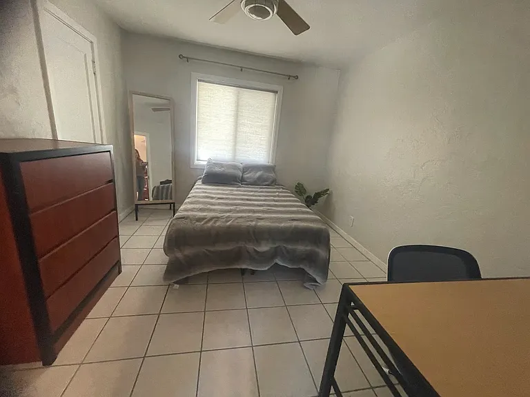 bedroom with double bed and desk, connecting to jack-and-jill bathroom.