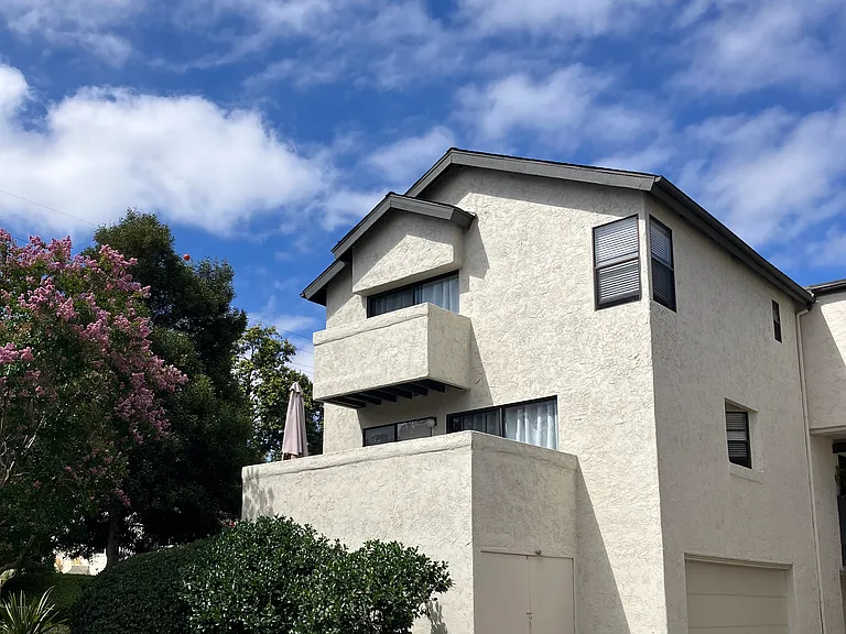 End unit with 2 patios and 3 stories.