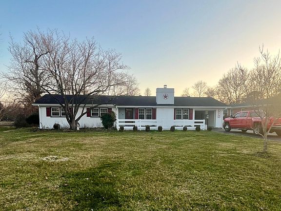 Full House Picture. Has Concrete Porch and White Picket Fence.