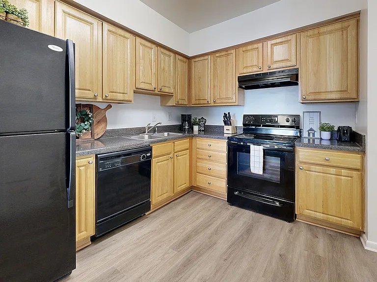 Kitchen with granite counters and black appliance package