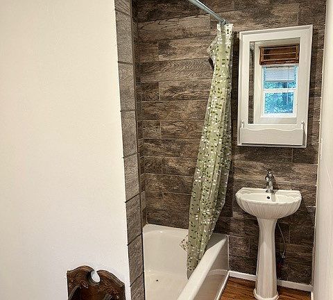 Full bath with washer and dryer.