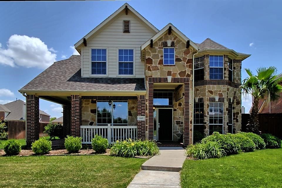 Gorgeous landscaping and wrap-around porch