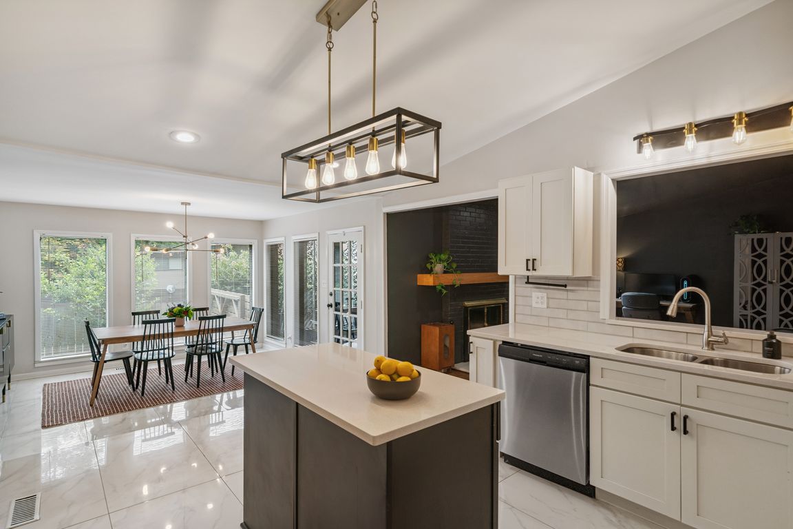09-Remodeled kitchen is open to the light-filled dining room and the den