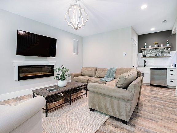 Great room with large flat screen TV and fireplace that provides extra warmth.