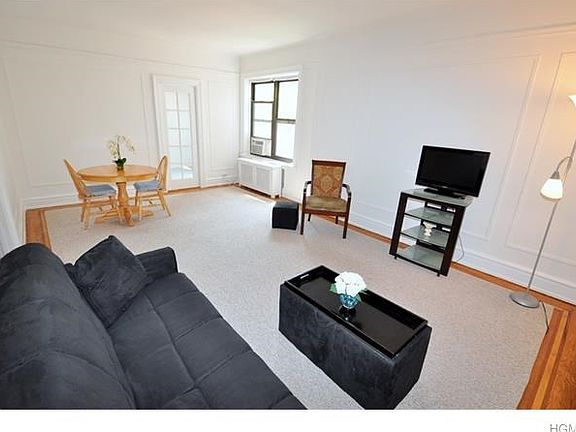 Large Living room has hardwood floors and in-laid trim.  The room has picture moldings, wall moldings and a cove ceiling.  There is a ten panel glass butler door to the eat-in-kitchen.  The room is 21'-0" x 13'-0".