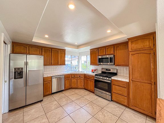 Large open kitchen with recessed lighting and stainless steel appliances