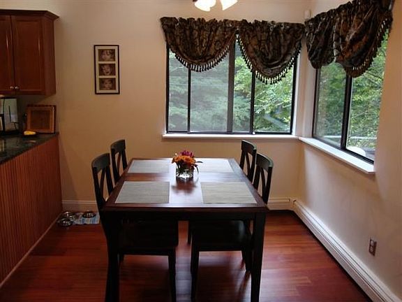 Eat in kitchen has granite counters and new stainless steel appliances.