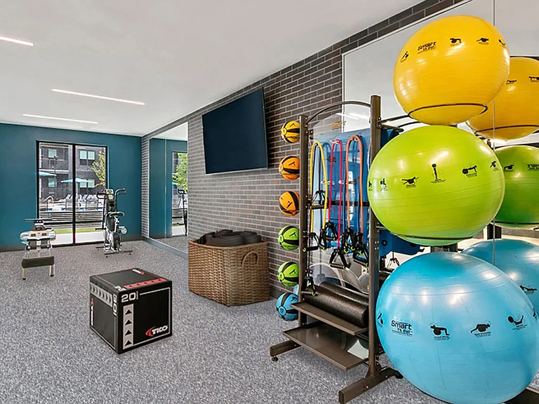 Separate fitness studio with Peloton bikes and virtual trainer