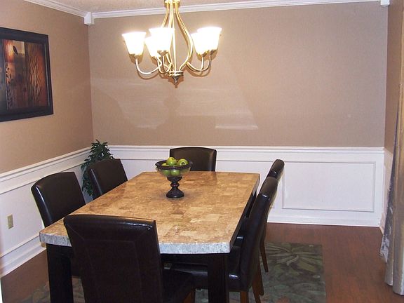 14' x 11' Dining Room with wainscoting panel and new wood laminate floors!