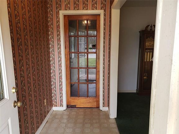 View from front door looking down foyer to door that leads to Family Room