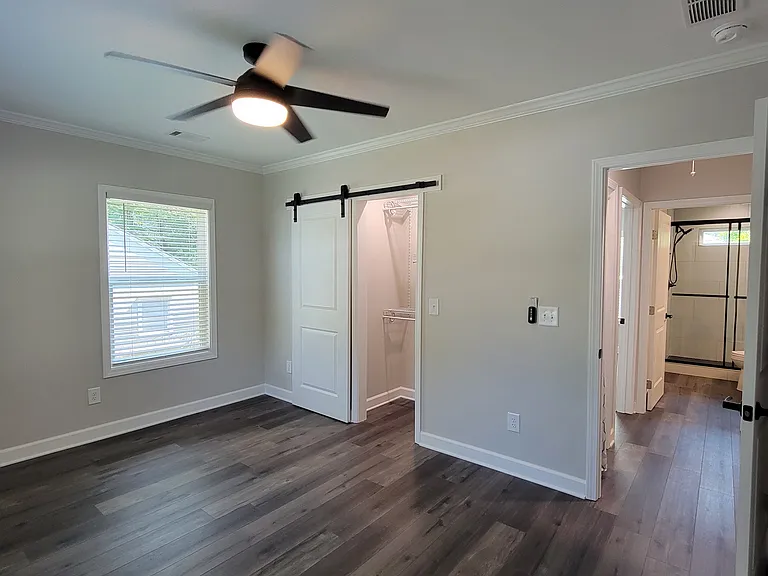 Front bedroom -- closet barndoor and shelving system in place to maximize floor space.