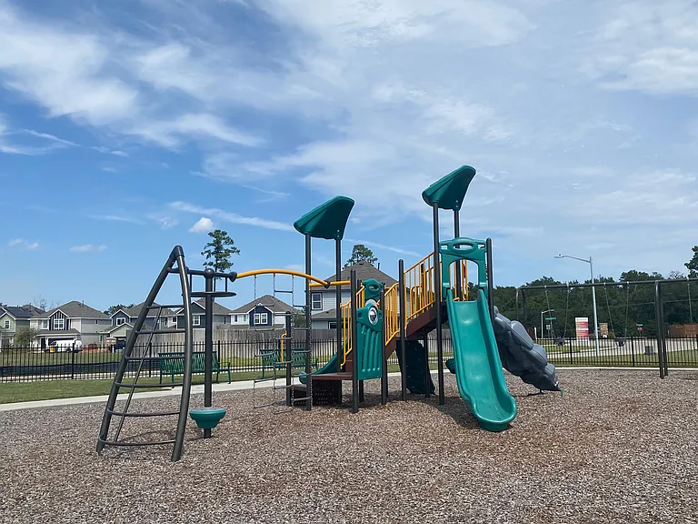 Inviting playground area with a vibrant slide and climbing structure, nestled in a family-friendly neighborhood. Inviting playground area with a vibrant slide and climbing structure, nestled in a family-friendly neighborhood.