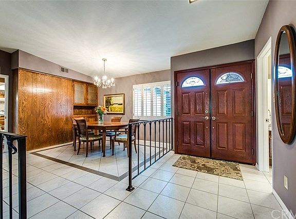 Front entry & view of formal dining room with built in cabinetry.