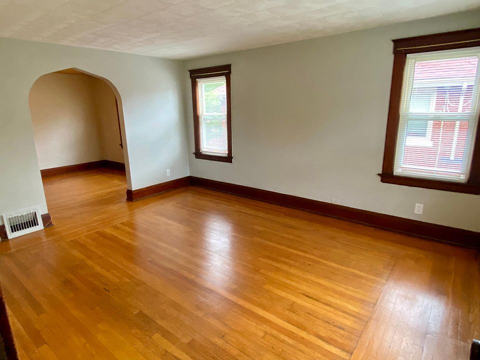 Large living room with plenty of natural light and beautiful hardwood flooring