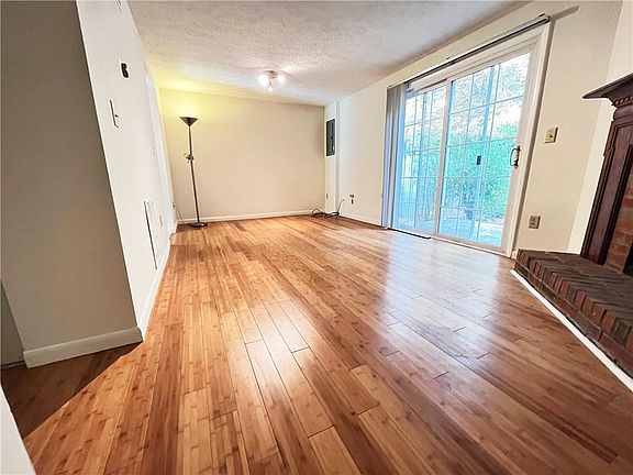 Den with fire place and door to yard.