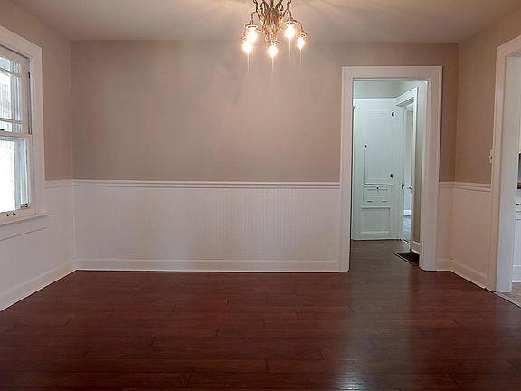 Dining room size ~13x10. New wood flooring, classic chandelier & fresh paint.