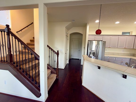 Wide entry hall with hardwoods and open flow to kitchen.