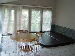 Spacious sunroom with submerged hottub