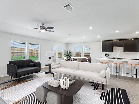 Virtually staged living room in the Preston floorplan at a Meritage Homes community.