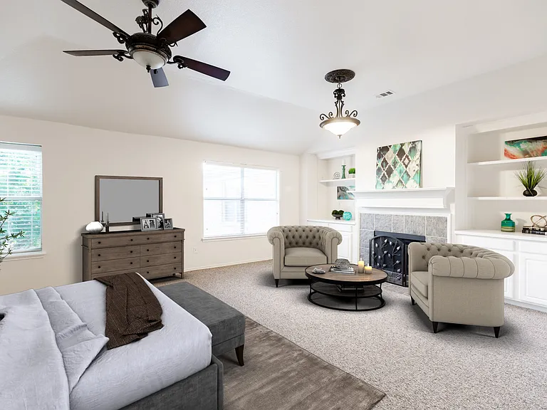 Virtually Staged - Primary bedroom upstairs with fireplace and sitting area
