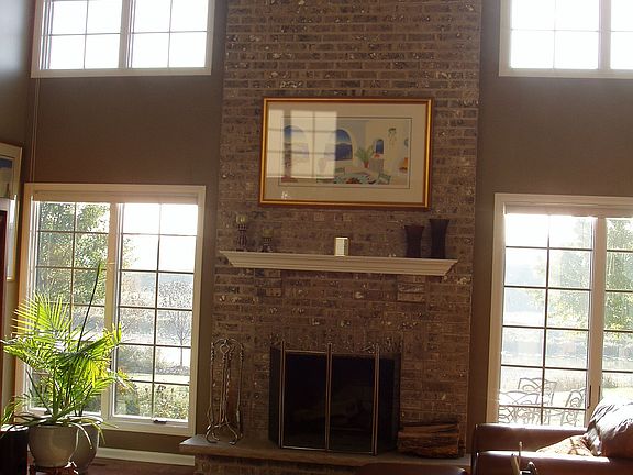 Two Story Living Room - floor to ceiling windos and brick fireplace