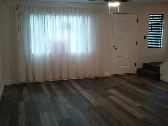 front room. additional pull shades behind main curtain. Perf