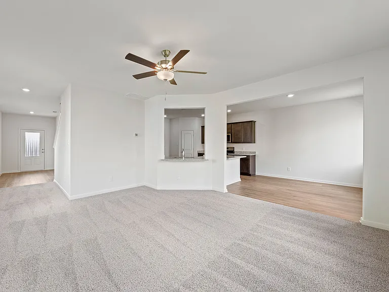 The open-concept layout of this floor plan has the kitchen, family room and dining room sitting next to one another.