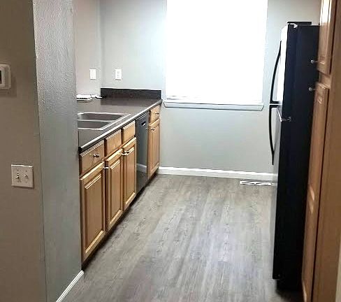 Kitchen with new flooring, blinds, and paint. Newer appliances and countertop