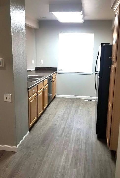 Kitchen with new flooring, blinds, and paint. Newer appliances and countertop