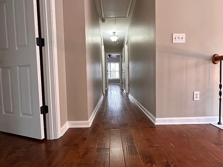 Upstairs Hallway. Master to the left; front bedroom immediately to your right, middle bedroom down the hall to your right, large bedroom over the garage at the end of the hall and hall bath and laundry room to the left as you walk down the hall.