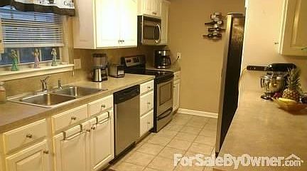 Open kitchen with appliances : The kitchen is good size and open allowing for space to cook your fam