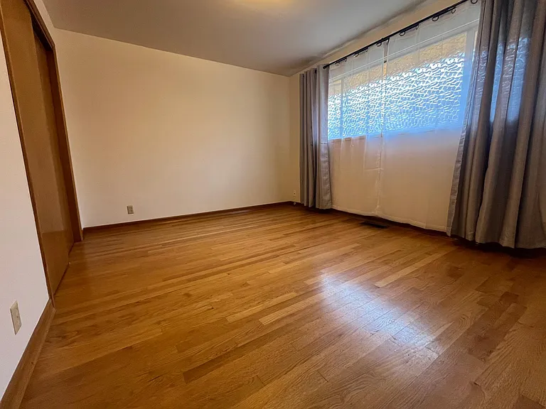 Bedroom 1- with hardwood floors and closet