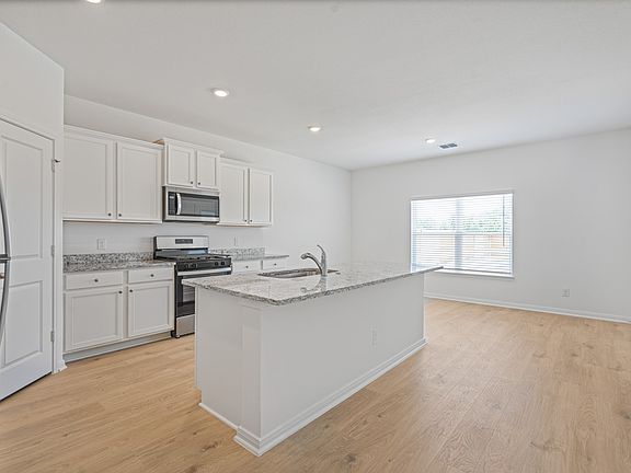 The kitchen comes with a full suite of energy-efficient appliances!