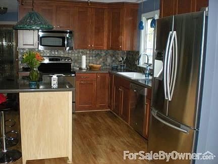 Downstairs bath
						:
						Glass tile, semi-recessed vessel sink and new tile floor