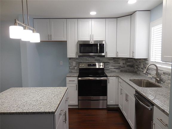 New granite countertops, lighting, appliances, backsplash and flooring.