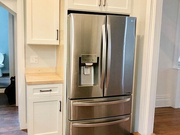 Large french door refrigerator with two bottom freezers. Includes filtered water and ice dispenser.