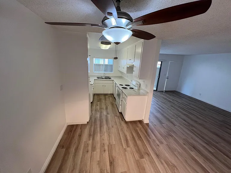 Standing in the dining room looking toward kitchen and living room, front entry door and patio. 1x1 downstairs