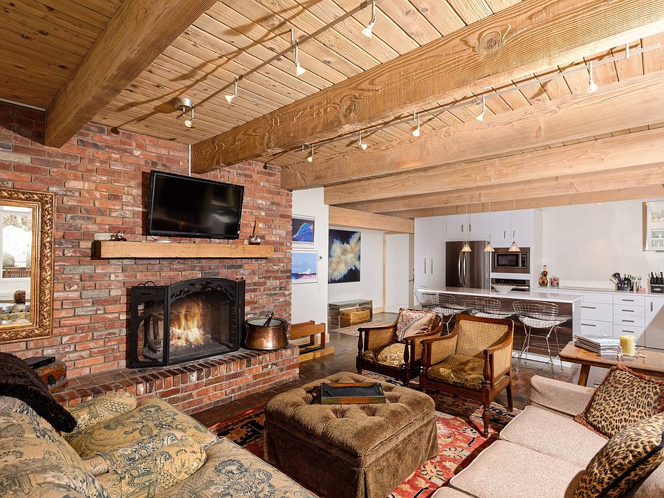 Walk into entrance right into open kitchen/dining/ living room. Modern kitchen and rare wood burning fireplace.