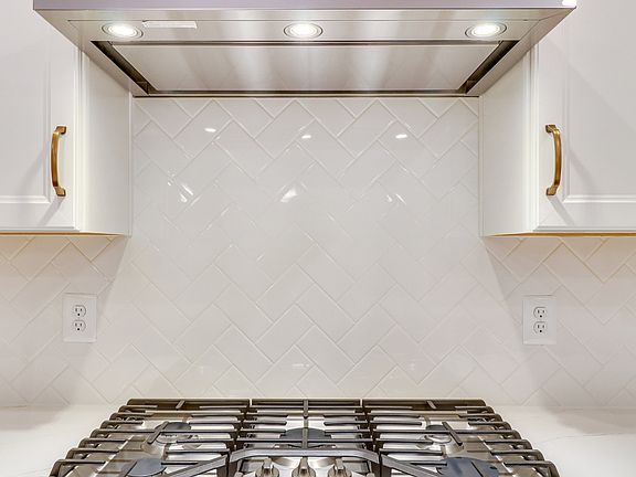 Herringbone backsplash in gourmet kitchen
